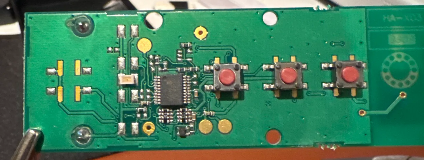 Somfy Telis 4 RTS PCB showing the three tactile buttons (UP, STOP, DOWN) and the central IC